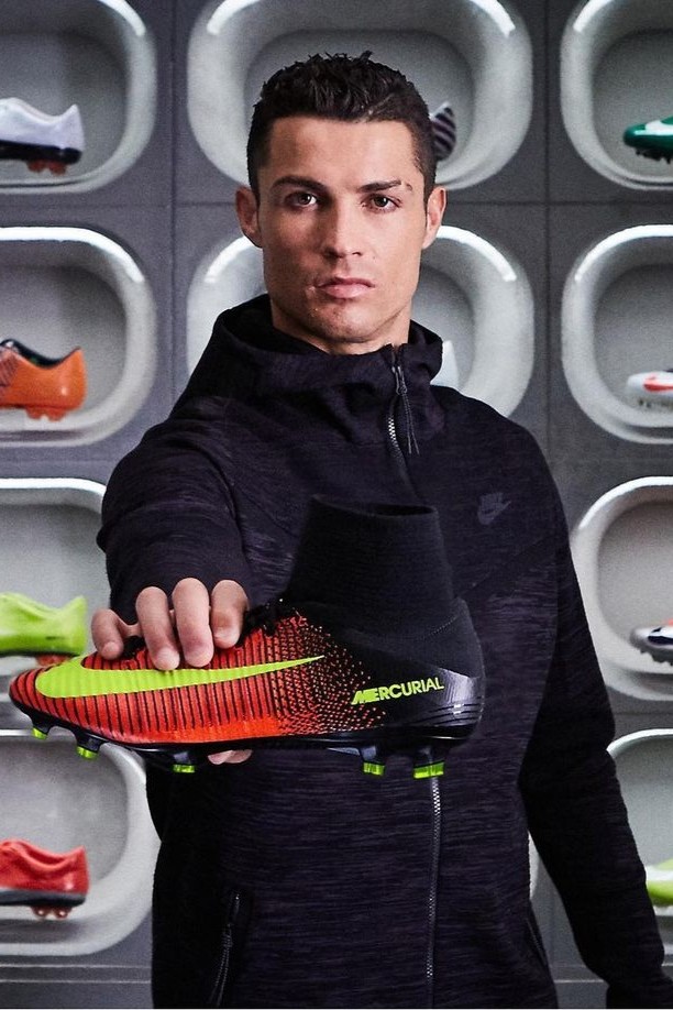 Ronaldo holds a red and black cleat